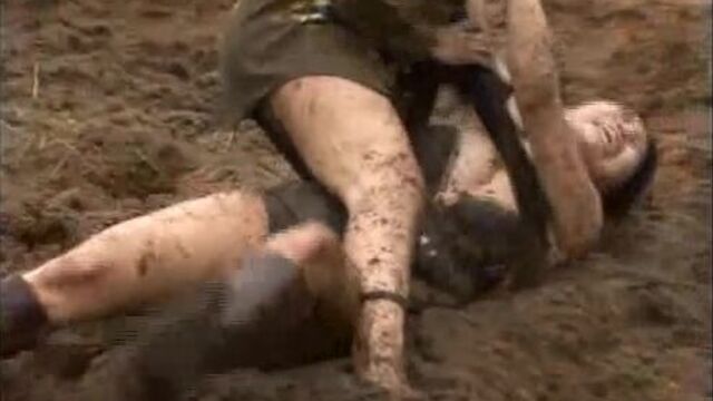 2 girls wrestling on manure field