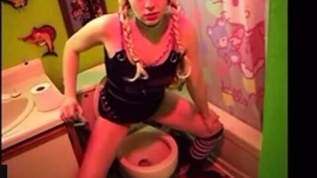 pretty blonde pooing a toilet